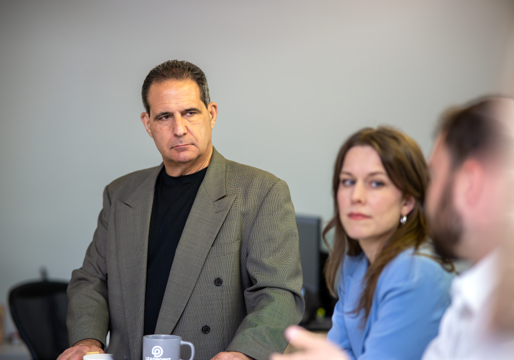President looking on during a company meeting.