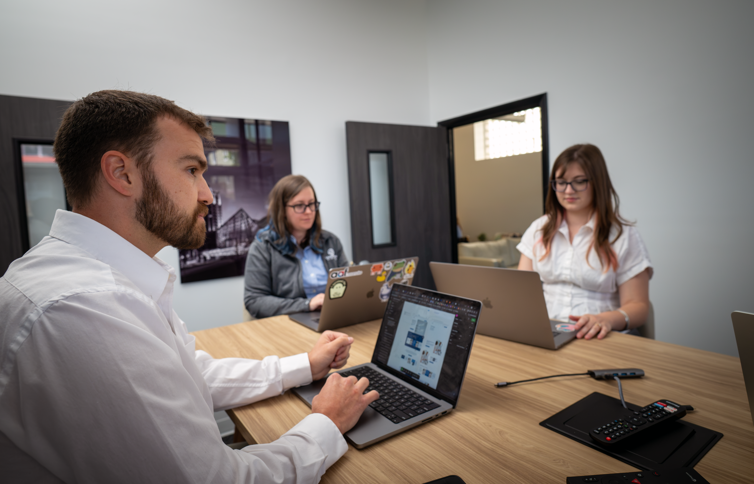 Development and design teams discussing a project in a conference room.
