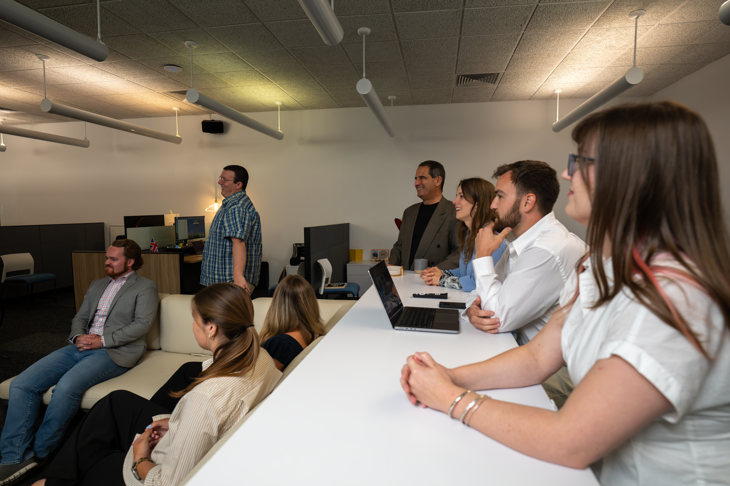 Team gathered in a common area in preparation for a meeting.
